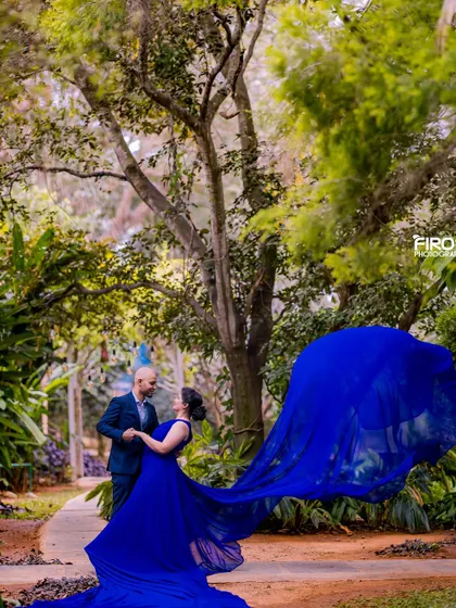 A candid shot of the couple dancing in the garden. The motion of the flowing blue gown adds a dynamic and romantic element to this beautiful pre-wedding photograph.