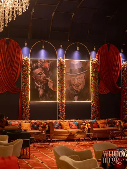 A cigar lounge corner I designed for the event, featuring classic leather sofas and portraits of famous cigar aficionados. This added another layer of thematic experience for the guests.