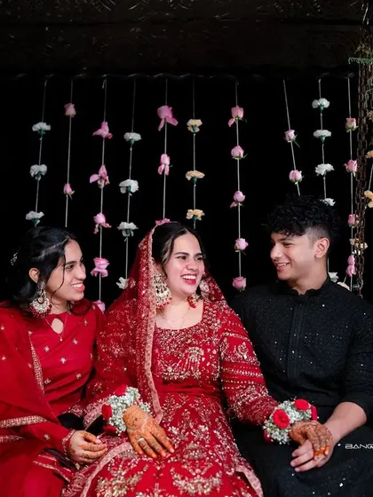 The bride shares a happy moment with her family and friends. Her smile is the centerpiece of this joyous group photo.