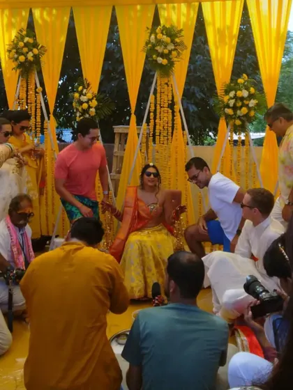A candid shot from a Haldi ceremony, where family and friends apply turmeric to the bride. It's these moments of pure joy and tradition that we love to create and manage.
