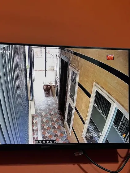 A focused view on an indoor corridor and staircase from the same Hikvision 4MP system.