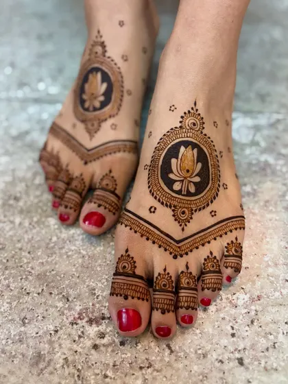 A simple and elegant feet design with a central lotus motif.