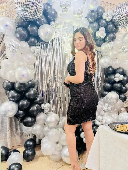 A beautiful shot of our client against the shimmering backdrop, showing off the full party look.