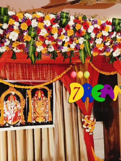 Here is a traditional wedding mantap decoration, perfect for Hindu ceremonies. The design uses bright yellow and red drapes with a dense arrangement of fresh marigolds and other colorful flowers.