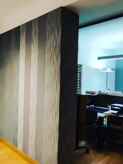 This fabric-wrapped acoustic partition features a gradient striped pattern, demonstrating how functional sound control can be integrated with a sophisticated design aesthetic.