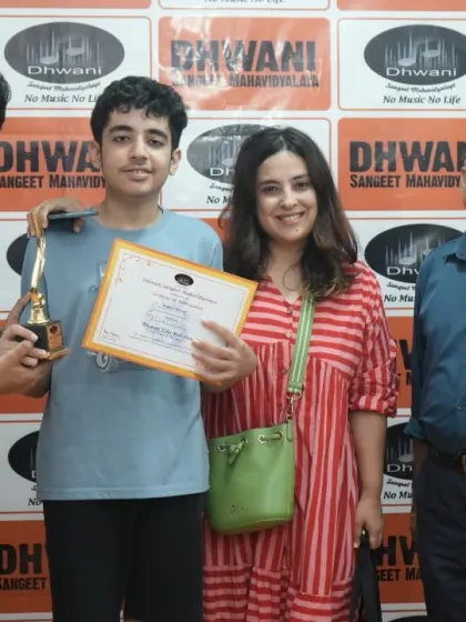 A student with his family and teacher, celebrating his award.