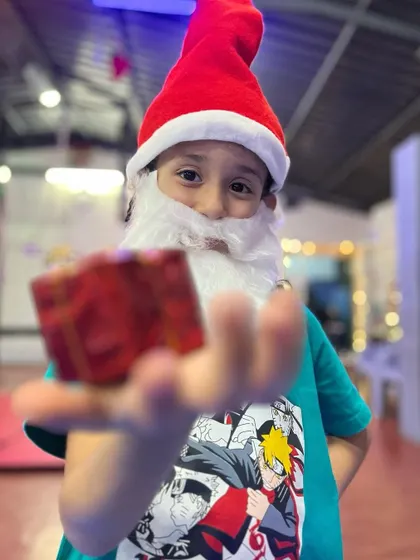 With a big bag of little dreams, Santa is here. This young Santa is ready to deliver gifts and joy at our studio's Christmas party.
