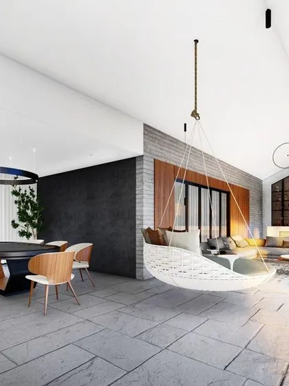 This render of the penthouse lounge highlights the seamless connection to the outdoor terrace. The large sliding glass doors and continuous flooring material blur the line between inside and out, creating an expansive entertainment area.
