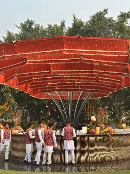 Our circular bar gets a festive makeover with a red canopy, ready to serve refreshing drinks during a daytime event.