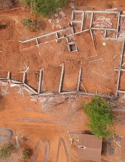 The foundation work for Ridge House, seen from a drone. This perspective shows the initial layout of the home on the ridge, the first step in bringing the architectural vision to life.
