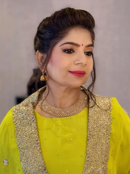 A close-up portrait showcasing the client's glowing makeup and elegant hairstyle. The look is polished and perfect for any special occasion.