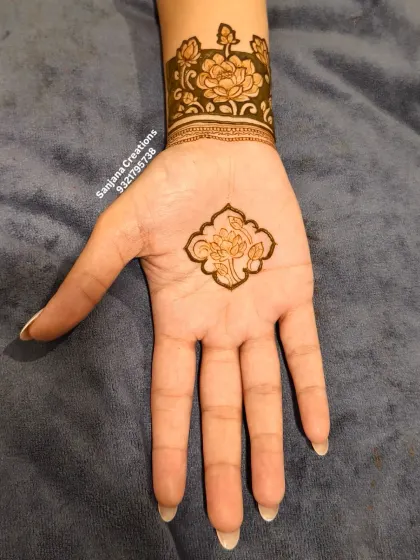 A minimal yet striking design with a single floral motif on the palm and a matching wrist cuff.