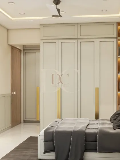 This angle of the Nissar Villa bedroom shows the full-height wardrobe with classic paneling and elegant gold handles. The design also includes a backlit open-shelf unit for displaying trophies and decor.