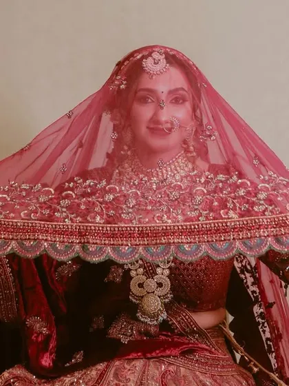 A classic bridal shot, with the bride looking through her embroidered veil. Timeless and elegant.