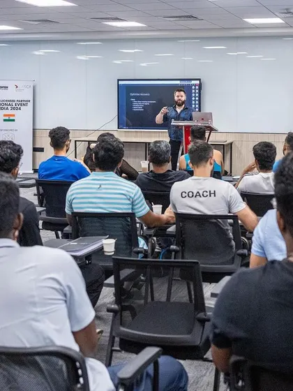 A wide shot of a speaker presenting to the audience at the 2024 UKSCA conference, held in our modern seminar facilities.
