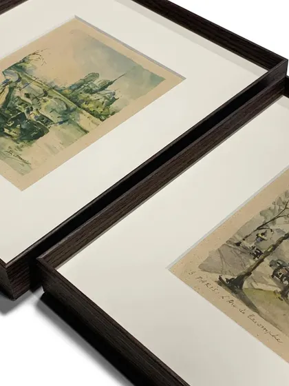 The rich, dark brown metal frames paired with crisp white mats create a classic and attractive presentation for these delicate watercolor landscape artworks.