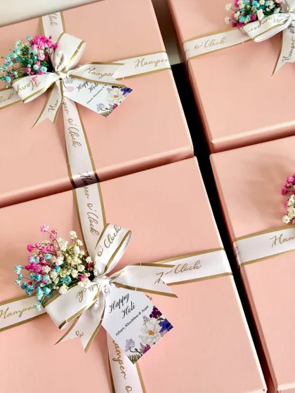 A little color and a lot of love for Holi. These return favor boxes are filled with festive essentials, including herbal gulaal, Ferrero Rocher chocolates, Shahi Thandai powder, and balloons to ensure a fun and safe celebration.