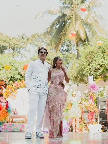 Love takes flight. The couple makes a spectacular entrance as guests release a shower of balloons, symbolizing their soaring journey into a beautiful forever.
