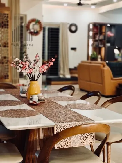 A beautifully set dining table at our latest site, offering a glimpse into the warm and inviting living space beyond. The design focuses on creating a cohesive and welcoming atmosphere.