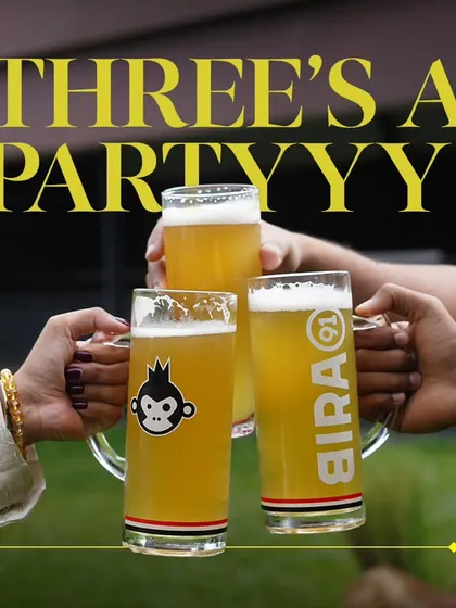 Three's a party! Celebrating International Beer Day with a toast among friends.