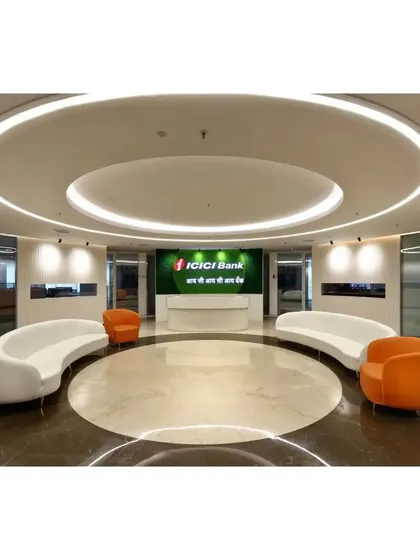 The grand reception lobby we designed for ICICI Bank, featuring a circular layout, bespoke curved seating, and layered ceiling lights to create a powerful first impression. This space embodies modern corporate authority and a welcoming visitor experience.