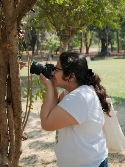 Me taking a close-up shot of a tree, finding beauty in the small details. Photography has taught me to see the world differently.
