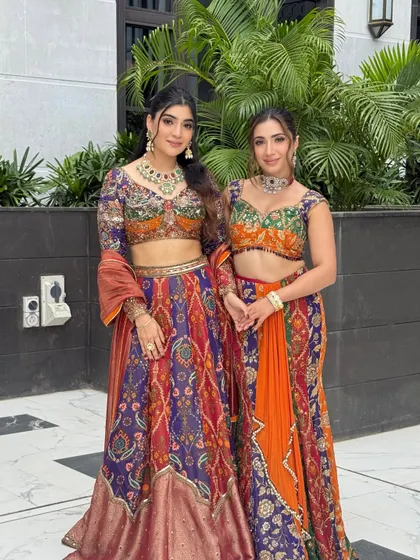 A beautiful portrait of two sisters in vibrant, colorful outfits. I created complementary minimal glamour looks for both to enhance their features without overpowering the dresses.