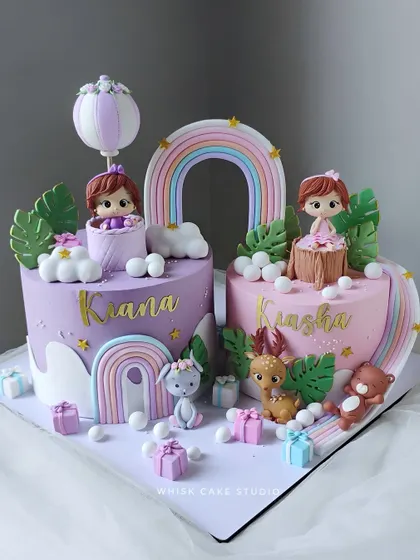 Twin cakes for twin girls. This beautiful set features two complementary cakes in pink and purple, each with its own unique details but a shared theme.