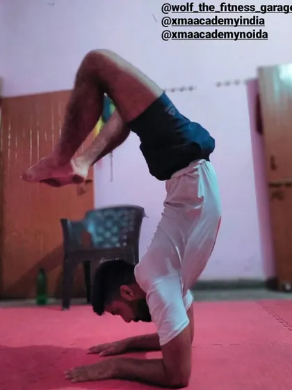 A true martial artist needs more than just strength; they need balance and flexibility. We integrate advanced yoga asanas, like this scorpion handstand, into our conditioning to build complete, resilient athletes.