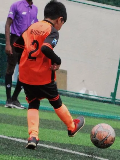 A back view of a U-9 player taking a shot, showing his jersey number. Every player is a valued member of the team.