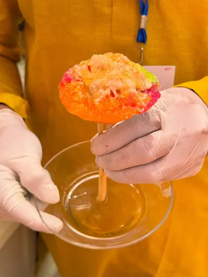 A colourful ice gola, or shaved ice candy, being prepared. This nostalgic treat is a fun and refreshing addition to a daytime event, especially for a Haldi or Mehendi.