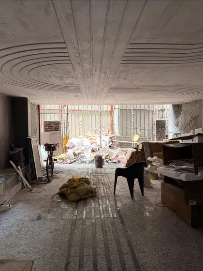 The process of creating a continuous inlay design, from the 2D plan to the messy on-site work, showing how the pattern is meticulously laid on the floor and ceiling.