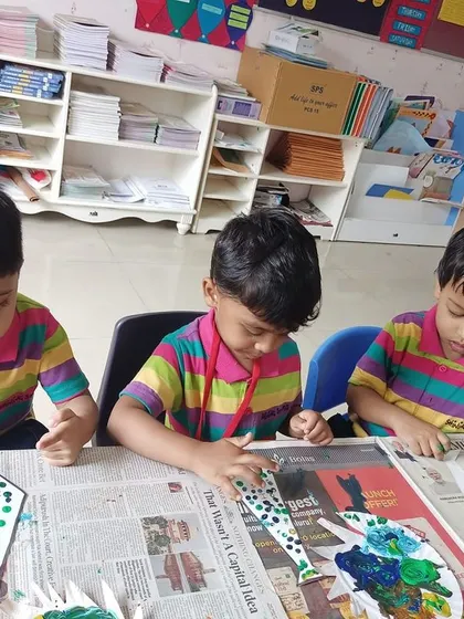Students are deeply engaged in painting and decorating their unique cards for Father's Day.