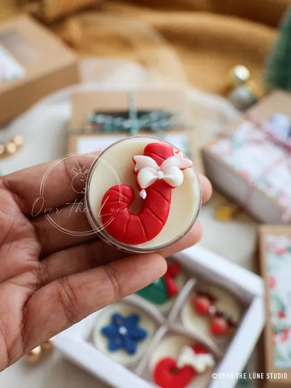 A close-up of the candy cane tealight, complete with a little white bow. These details are what make my handmade candles so special.