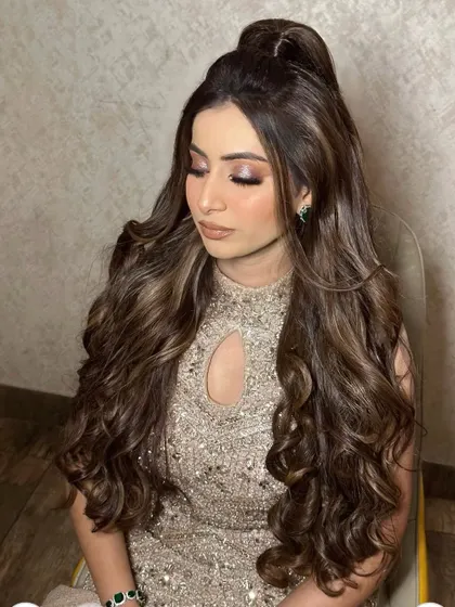 Princess vibes all the way. This half-up style with voluminous curls is perfect for a cocktail party or reception, giving you that royal, elegant feel.