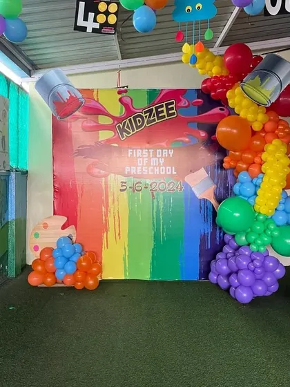 Another view of the paint-themed decor for the first day of preschool. The artificial grass flooring adds to the playful and kid-friendly environment.