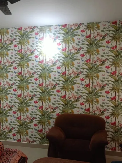 A colorful tropical wallpaper with palm trees, flowers, and butterflies. This cheerful and lively design is great for brightening up any room.