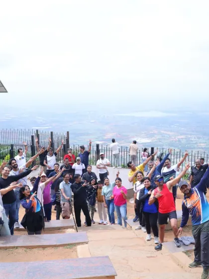 A team of doctors celebrating at the top of Nandi Hills. Our treks are a great way for busy professionals to de-stress, connect with peers, and enjoy the open skies.