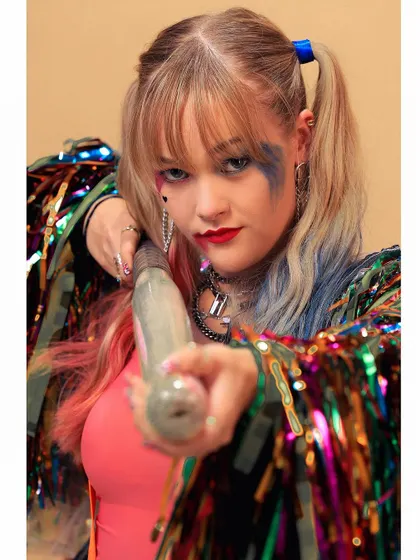 "Time to play." A close-up from our Harley Quinn cosplay shoot, focusing on the character's mischievous expression and signature pigtails.