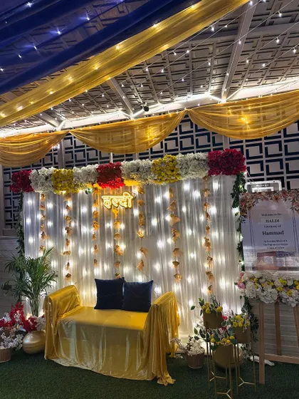 The complete terrace Haldi setup, showing the seating area, welcome sign, and the beautiful ceiling decor that creates a magical ambiance.