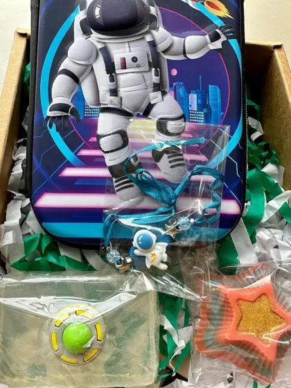 Another version of the astronaut-themed gift box, featuring a hard case pencil box and various space-themed soaps.