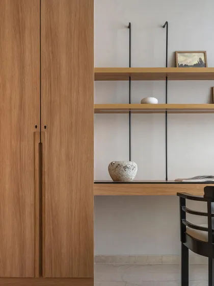 A detail of the custom study area in Apartment 3201. The minimalist shelving system and clean oak wood create a functional and aesthetically pleasing workspace.
