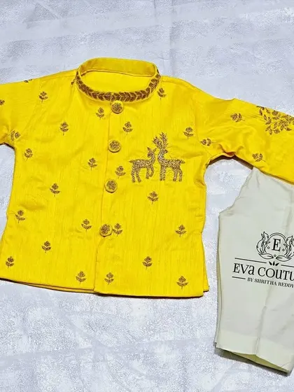 A bright yellow kurta set for a newborn. The kurta features delicate deer embroidery on the body and sleeves.