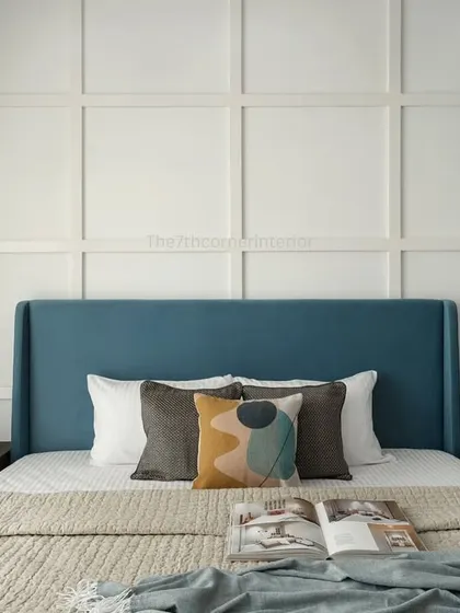 A frontal view of the parents' bedroom, emphasizing the symmetry of the design with the paneled wall, matching nightstands, and the calming effect of the blue and white color scheme.
