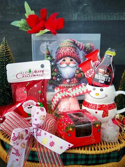 A Christmas gift basket pairs packaged treats and a snowman mug with Santa decorations, as another option in our festive range.