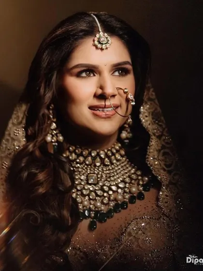 A close-up of the beautiful bride, showcasing her soft, wavy hairstyle.