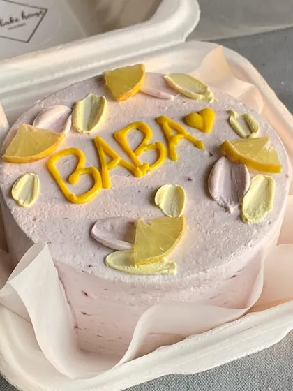 A personal bento cake for "Baba" decorated with cute, hand-piped lemon slices. Custom messages and designs make these little cakes extra special.