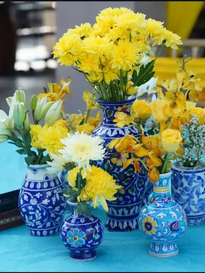 A beautiful collection of blue pottery vases used as centerpieces. Filled with bright yellow flowers, these created a stunning contrast and added a touch of Rajasthani craft to the decor.