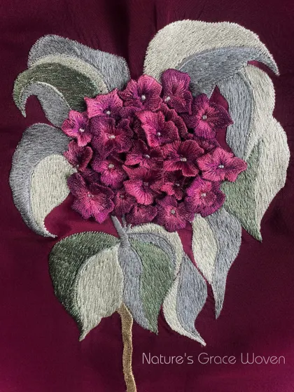 Nature's grace, woven. A stunning 3D embroidery of a hydrangea flower, with each tiny petal individually crafted to create a lifelike cluster.
