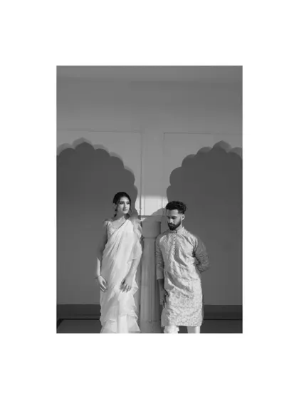 A striking black and white portrait of a couple, using the strong shadows of Indian arches to create a graphic and modern composition.